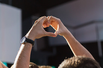 Image showing close up of fan hands showing heart at concert
