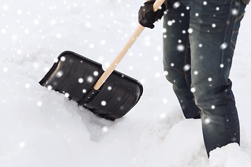 Image showing closeup of man digging snow with shovel