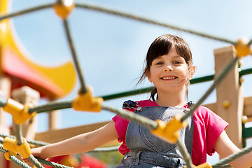 Image showing happy little girl climbing on children playground