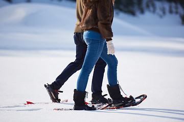 Image showing couple having fun and walking in snow shoes