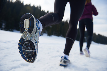 Image showing couple jogging outside on snow