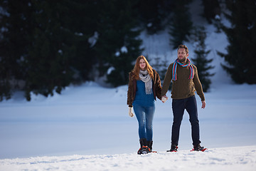 Image showing couple having fun and walking in snow shoes