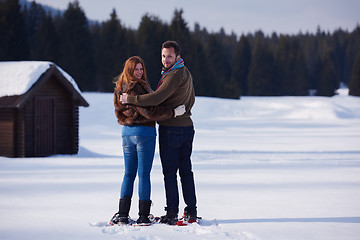 Image showing couple having fun and walking in snow shoes