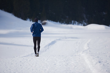 Image showing jogging on snow in forest