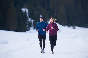 Image showing couple jogging outside on snow