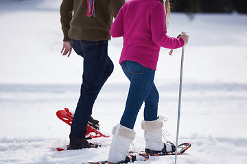 Image showing couple having fun and walking in snow shoes