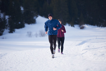 Image showing couple jogging outside on snow