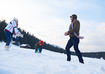 Image showing happy family playing together in snow at winter