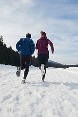 Image showing couple jogging outside on snow