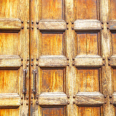 Image showing abstract texture of a brown antique wooden old door in italy   e