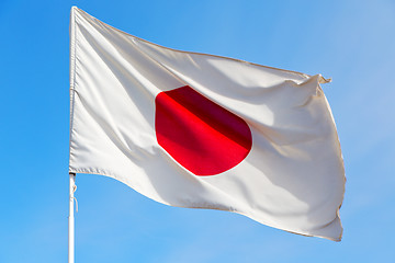 Image showing japanb waving flag in the blue sky 