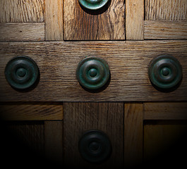 Image showing in london antique brown door  rusty  brass nail and light