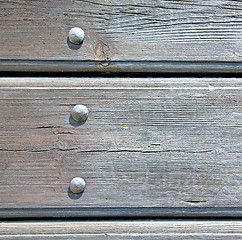 Image showing abstract texture of a brown antique wooden old door in italy   e