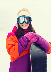 Image showing happy young woman with snowboard outdoors