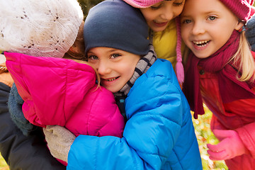 Image showing group of happy children hugging in autumn park