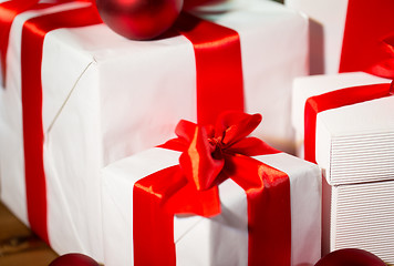 Image showing close up of gift boxes and red christmas balls
