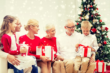 Image showing smiling family with gifts at home