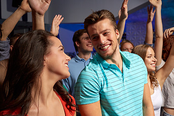 Image showing smiling friends at concert in club