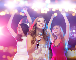 Image showing happy women singing karaoke and dancing