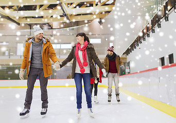 Image showing happy friends on skating rink