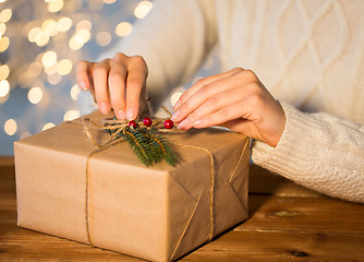 Image showing close up of woman with christmas gift or parcel