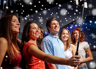 Image showing friends with smartphone taking selfie in club