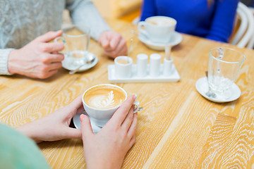 Image showing close up of hands with coffee cup at cafe