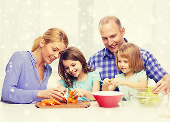 Image showing happy family with two kids making dinner at home