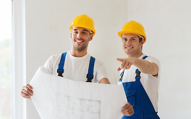 Image showing group of builders with blueprint