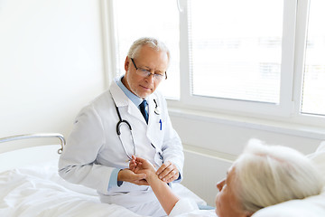 Image showing doctor checking senior woman pulse at hospital