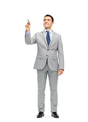 Image showing happy businessman in suit writing something