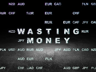 Image showing Money concept: Wasting Money in grunge dark room