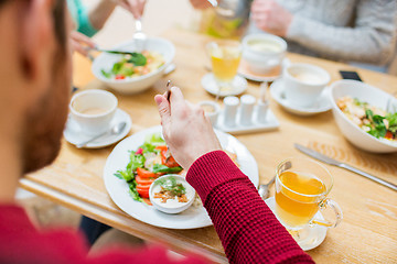 Image showing close up friends having dinner at restaurant