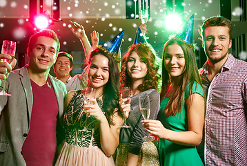 Image showing smiling friends with glasses of champagne in club