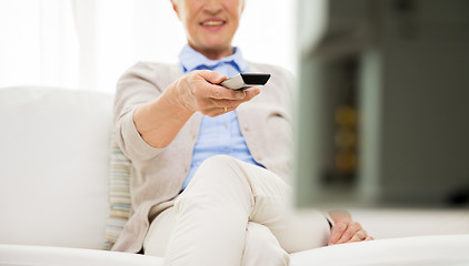 Image showing close up of happy senior woman watching tv at home