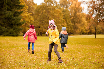 Image showing group of happy little kids running outdoors