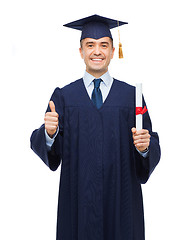 Image showing smiling adult student in mortarboard with diploma