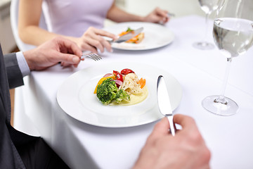 Image showing close up of couple eating appetizers at restaurant