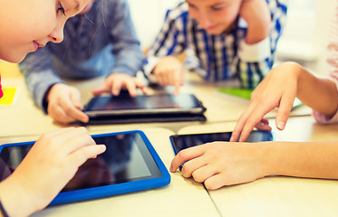 Image showing close up of school kids playing with tablet pc 