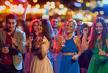 Image showing happy friends with champagne dancing at nightclub