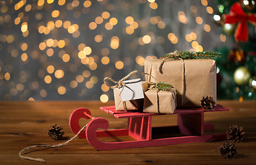 Image showing close up of christmas gift boxes on wooden sleigh