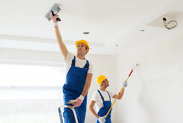 Image showing group of builders with tools indoors