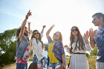 Image showing happy young hippie friends dancing outdoors