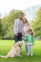 Image showing happy family with labrador retriever dog in park