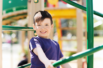 Image showing happy little boy climbing on children playground