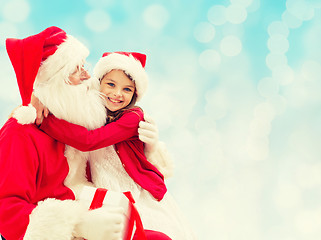 Image showing smiling little girl with santa claus