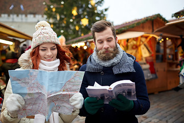 Image showing happy couple with map and city guide in old town