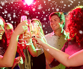 Image showing smiling friends with glasses of champagne in club