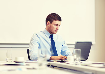 Image showing businessman with laptop working in office