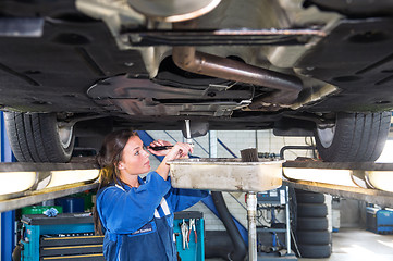 Image showing Mechanic changing the oil of a vehicle